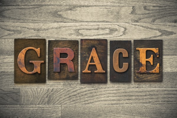 The word GRACE written in wooden letterpress type