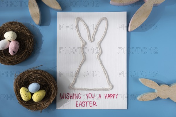 Handmade greeting card with EASTER bunny HAPPY EASTER written in beautiful handwriting. Gesture shows excitement and joy for the upcoming event. Springtime holiday gift present zero cost ideas. Creative art preparation