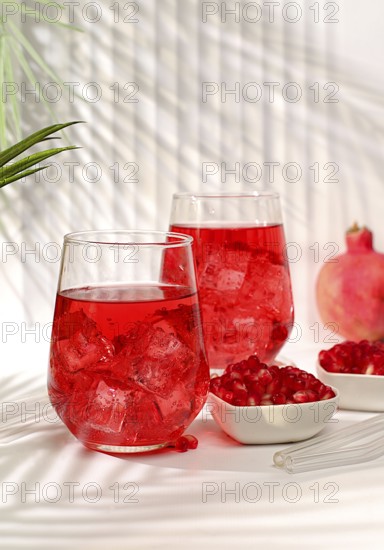 Pomegranate fruit juice and ingredients, summer pomegranate drink on bright table, detox diet and weight loss concept, healthy and natural food, source of vitamin C, selective focus, space for text