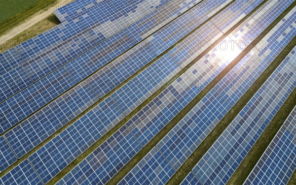 Solar panel field at work with sun reflection