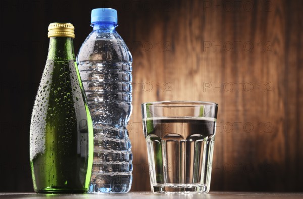Composition with glass and bottles of mineral water