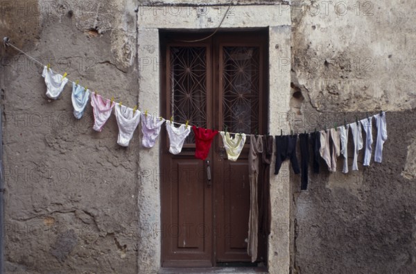 Clothesline in front of front door in Alfama, the old town of Lisbon, Portugal