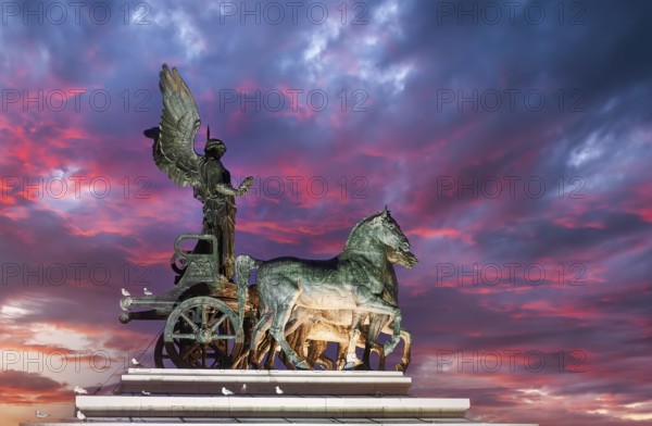 The Quadriga of Unity on the summit of one of the two propylaea at the Victor Emmanuel II National Monument (Vittoriano) at sunset. Rome Italy