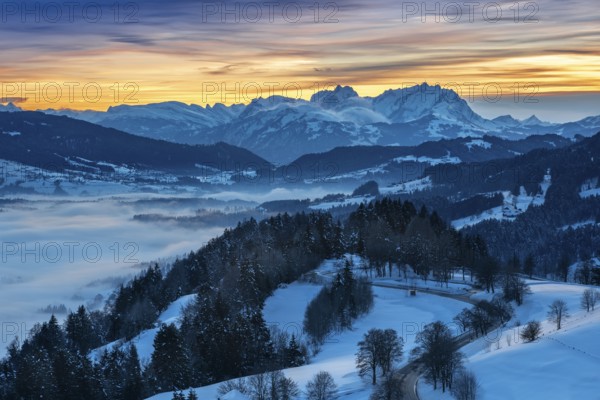 Dreamlike winter landscape at sunset with a view from the Allgäu Alps over the Bregenzerwald in Austria to the Säntis in Switzerland