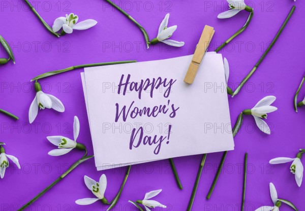 Happy Womens Day lettering greeting card. Spring flowers snowdrop. Beautiful tender bouquet of flowers. Holiday concept. Creative modern