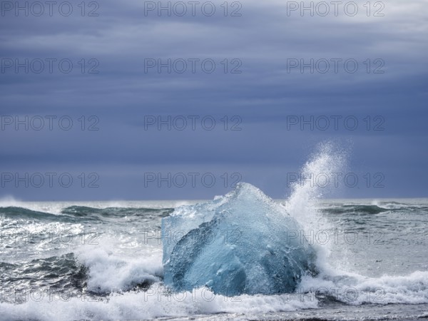 Diamond Beach, iceberg in the surf, near Jökulsarlon glacier lagoon, Vatnajökull National Park, Hornafjörður, South Iceland, Iceland