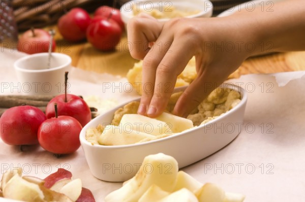 Detail of child hands making apple pie, lodz, poland