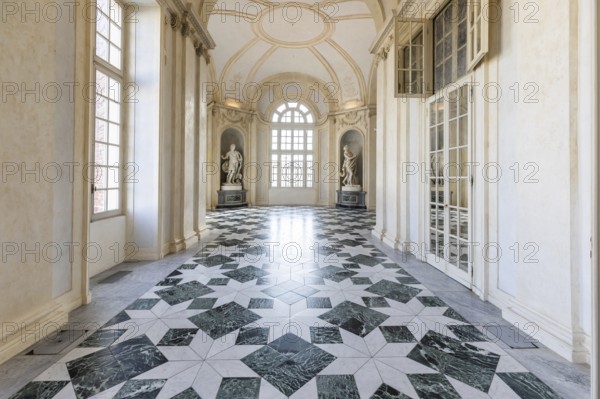 Venaria Reale, Italy, January 2023: luxury interior old royal palace. Gallery perspective with window