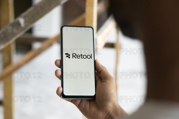 retool logo is displayed on smartphone. Retool is a fast way to build internal tool