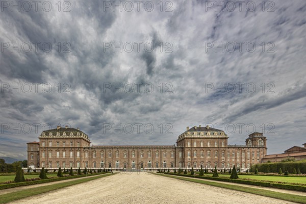 Impressive view of a large baroque palace with clouds in the sky, Palace of Venaria Reale, Residences of the House of Savoy, Turin, Piedmont, Italy