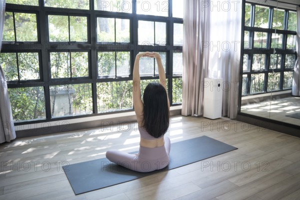 Female happiness Attractive young asian woman doing yoga stretching exercise on mat yoga & fitness exercises. Healthy lifestyle Calmness and relax