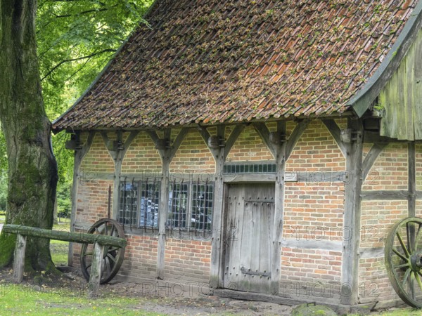 Old half-timbered house with tiled roof, surrounded by trees and nature, Bad Zwischenahn, ammerland, germany