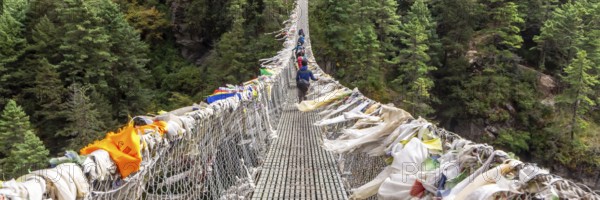 Suspention bridge on the Everest Base Camp Trek, Himalaya mountains, Sagarmatha National Park, Nepal. Web banner in panoramic view