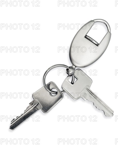 Metal key with trinket over white background