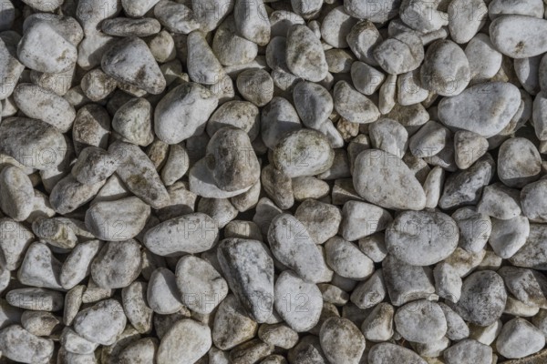 Gravel quarry - round rock and river gravel as background, bird's eye view