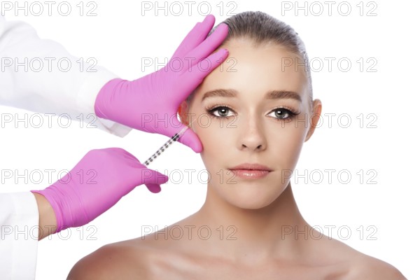 Beautiful face crows feet injection Cosmetic skincare spa beauty treatment with pink gloves by eye, on white, Atlanta, USA