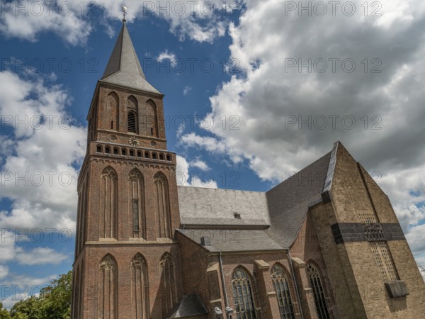 Gothic church under a bright blue sky with white clouds, emmerich, lower rhine, germany