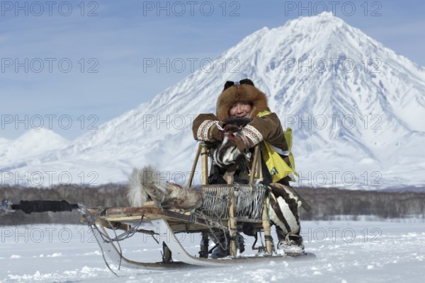KAMCHATKA, RUSSIA, FEB 25, 2017: Kamchatka musher Mandyatov Roman dressed in national clothes rides on traditional sled of indigenous peoples of Kamchatka. Kamchatka Sled Dog Racing Beringia, Russian Cup of Sled Dog Racing (snow disciplines)