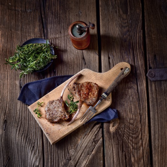 Grilled lamb chops on an old board
