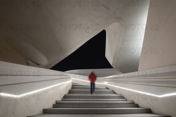 Unrecognized person walking at the stairs leading to a bright open space. Eleftheria square Nicosia Cyprus