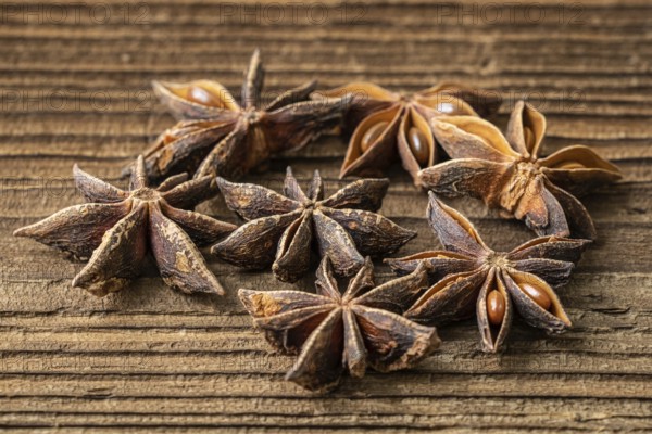 Dried star anise spice on vintage wooden board