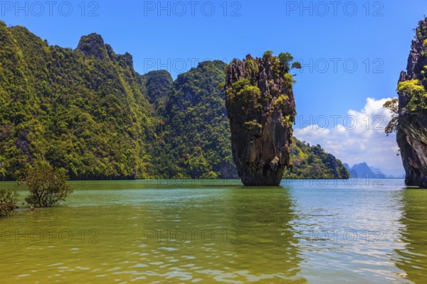 The tourist season in Thailand. Calm and warm sea and picturesque quaint island. James Bond Island