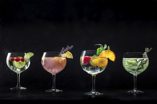 Fancy cocktails with fresh fruit. Gin and tonic drinks with ice at a party, on a black background, with copy space, Food photography, Food photography