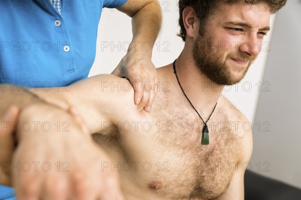 An image of a young man at the physio therapy with pain