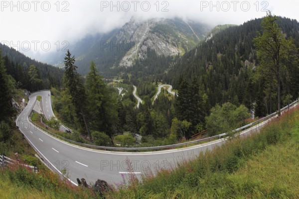 A winding mountain road - Serpentine, lighted autumn sun. Photo taken by lens Fisheye