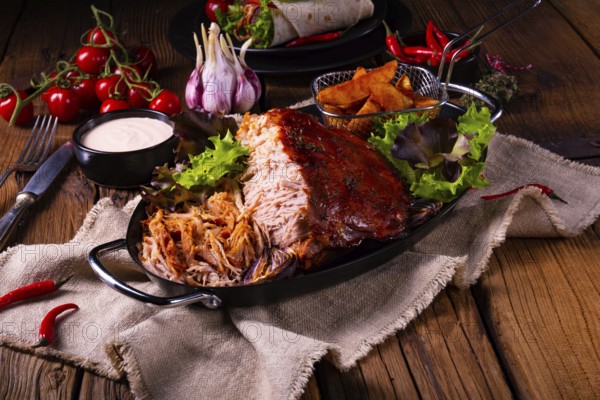 Delicious pulled pork with jacket potato quarters