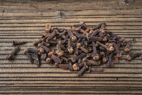 Clove spice on a wooden board, Syzygium aromaticum