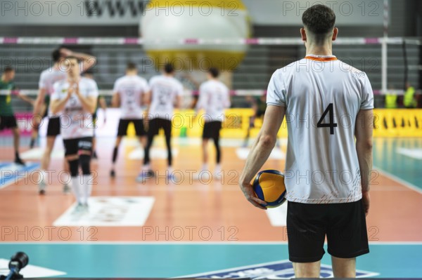 Volleyball player serves ball during the match