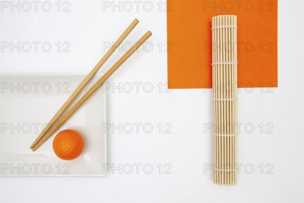 Top View Of White Empty Sushi Plates With Bamboo Chopsticks and Golf Ball. Golf Design