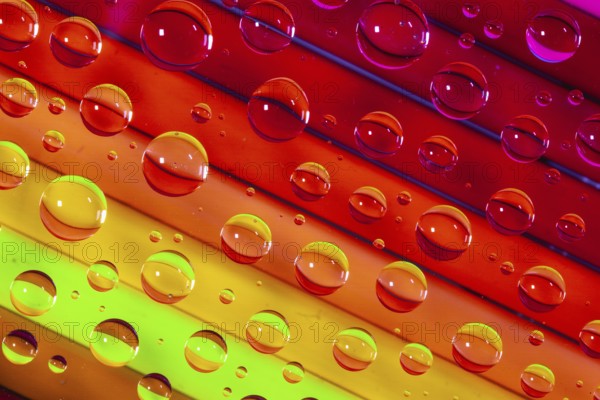 Color pencils under glass with drops of water. Office concept