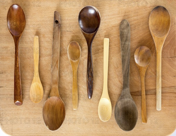Wooden spoons on a wooden background from above. Studio shot. Kitchen utensil