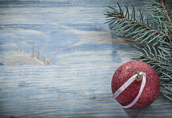 Pine branch Christmas ball on wooden board copy space holidays concept
