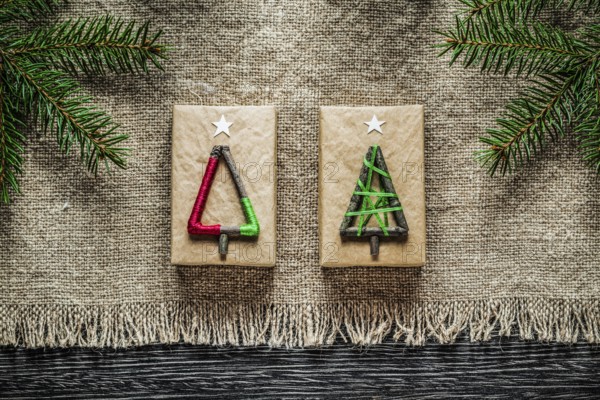 Vintage sacking pine branch Christmas gift box on wooden board