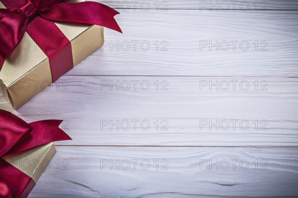 Box-containers with presents on wooden board copy space holidays concept