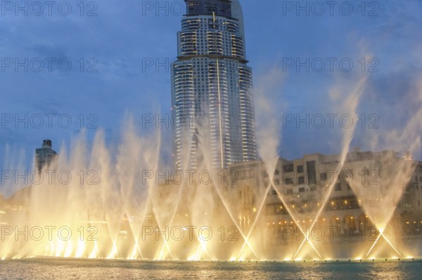 The Dancing Fountain of Dubai performs to the beat of the music at night show on lake area