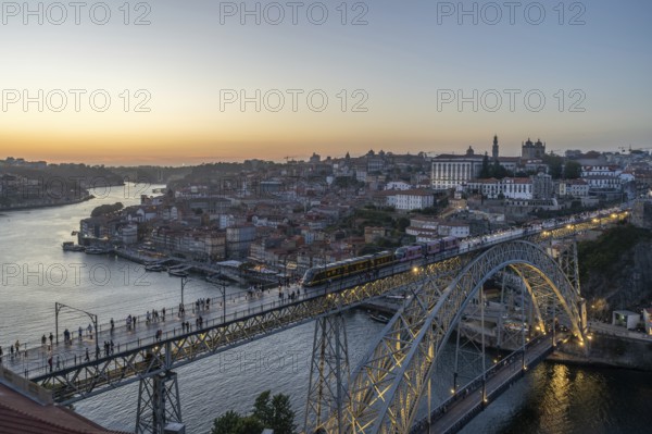 Illuminated Porto City, Douro River and Dom Luis bridge I with Tram. View from Tourist Viewpoint Miradouro da Serra do Pilar at Evening Twilight. Portugal