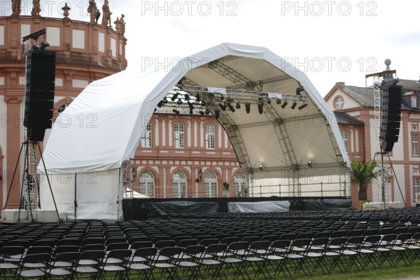 Wiesbaden, Germany - July 14, 2016: A concert stage set up with rows of seats for a classical concert on the palace grounds with Biebrich Palace in the background on 14 July 2016 in Wiesbaden, Germany