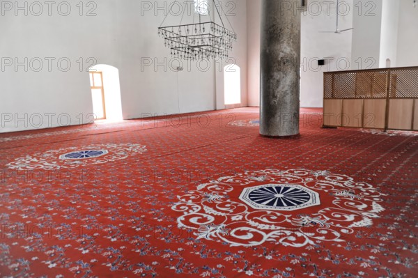 Interior of a mosque with red prayer rug and patterns, journey to Aphrodisias, Turkey