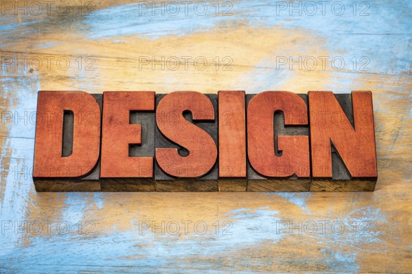 Design word typography - text in vintage letterpress wood type blocks against grunge wooden background