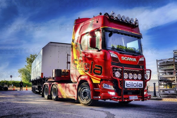 Red Next Generation Scania truck in front semi trailer of Eilola Logistics Oy, special transport. Helsinki, Finland. July 27, 2021., Filtered image
