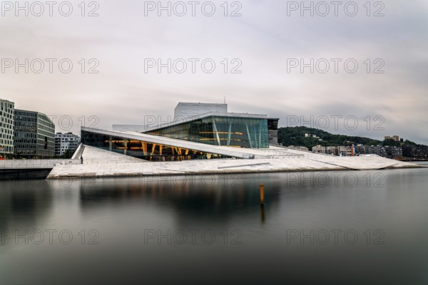 Oslo, Norway, August 10, 2019: Exterior view of Opera house in Oslo. Long exposure at dusk. New modern building designed by Snohetta architects. It is the National Theater of Opera and Ballet of Norway