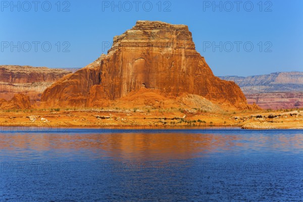 Concept of active and photo tourism. Lake Powell is a reservoir on the Colorado River, USA. Picturesque lake with blue water, among rocks of red sandstone. Great cruise on a passenger boat