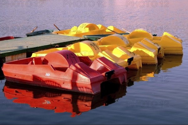 On a dock Colorful boats on a dock in a pond