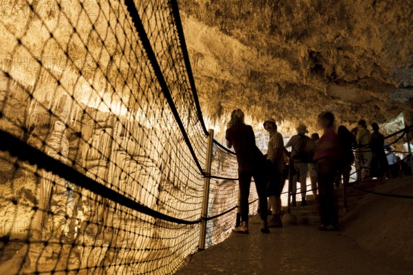 Tourists admire the incredible cave of Neptune. Alghero, Sardinia. Italy