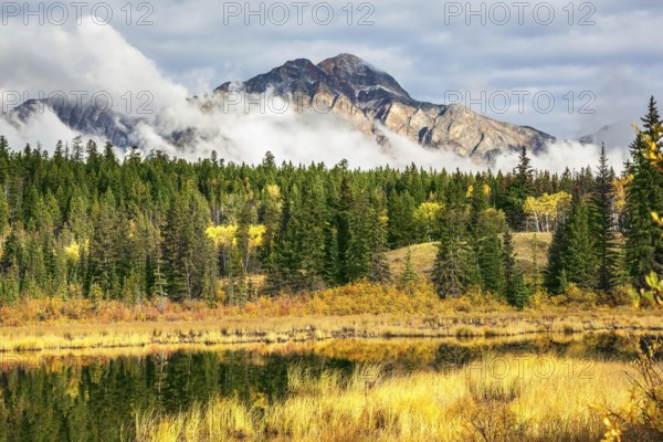 Patricia Lake. Picturesque little lake surrounded by yellow and orange autumn grass and trees. Jasper National Park in the Rocky Mountains