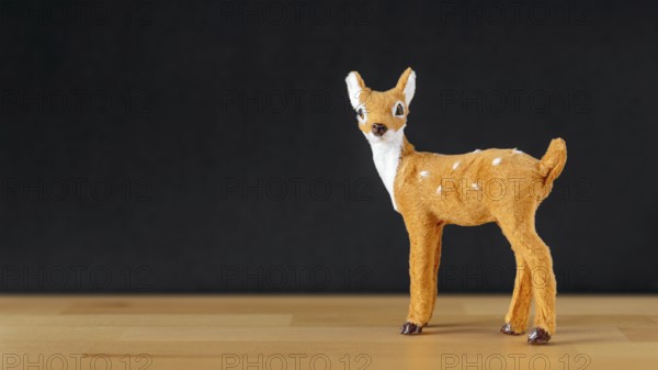 An image of a Christmas decoration deer on black background